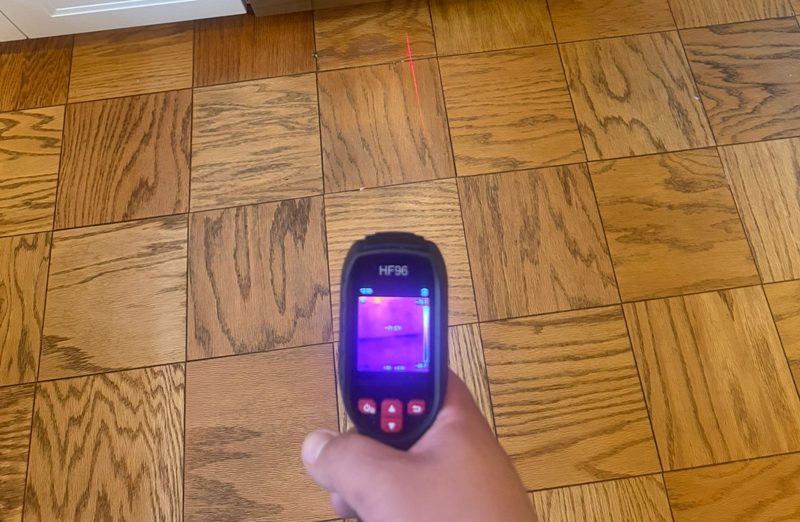 Thermal camera held over an oak parquet floor beside the dishwasher in a home in Southwest Waterfront, Washington, DC, September 2026