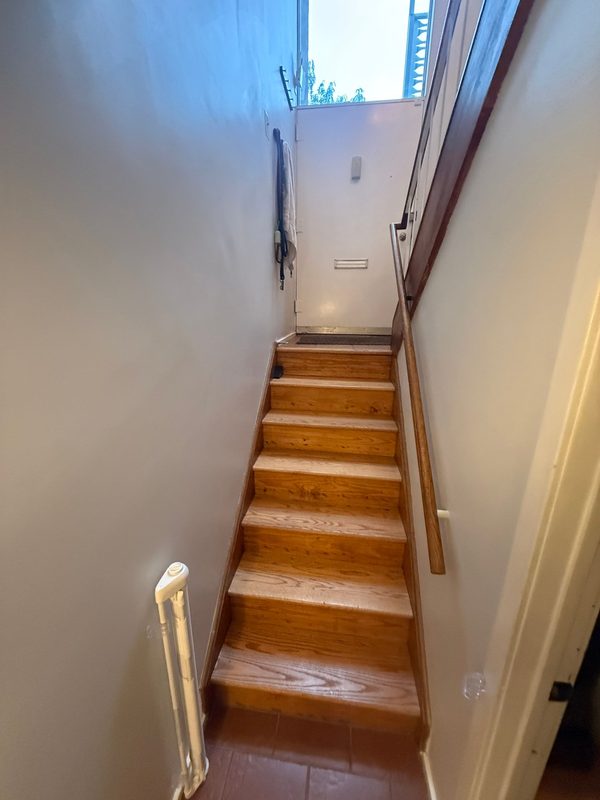 Narrow wooden stair between levels of a home in Southwest Waterfront, Washington, DC, September 2026